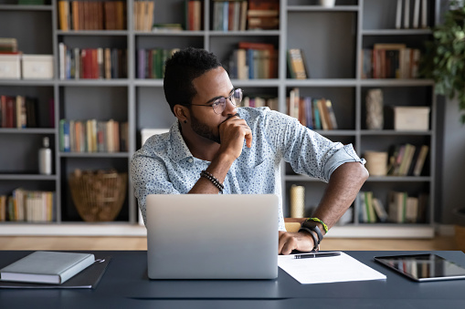 marketer with laptop thinking